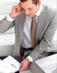 Young business man talking on phone over paperwork