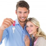 Young couple with keys to their new home