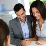 Couple speaking with a solicitor and checking documents