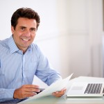 Man in blue shirt working in an office