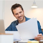 Man smiling looking at documents.