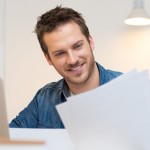 Man smiling looking at documents.