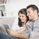 Young couple looking tablet pc at home