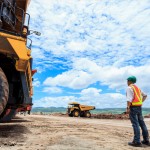 Engineer with trucks on mining site