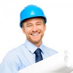 Smiling engineers standing with blueprints in hand