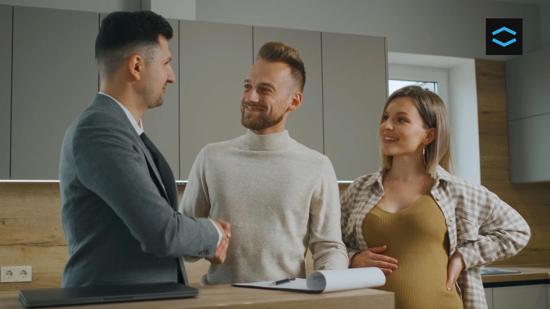 A couple thanking a mortgage broker for helping them find their dream home