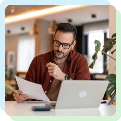 Man on the phone looking at a tablet, researching bad credit home loan options.