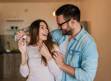 Couple holding a key to their dream house