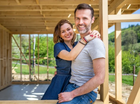 couple hugging eachother in unfinished home