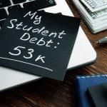 Laptop with a post it about student debt