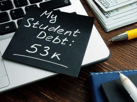 Laptop with a post it about student debt