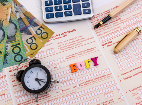 ATO tax debt form with calculator, pen, clock and money