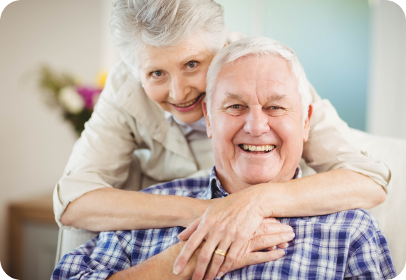 an elderly couple hugging