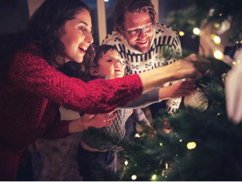 A family decorating a christmas tree